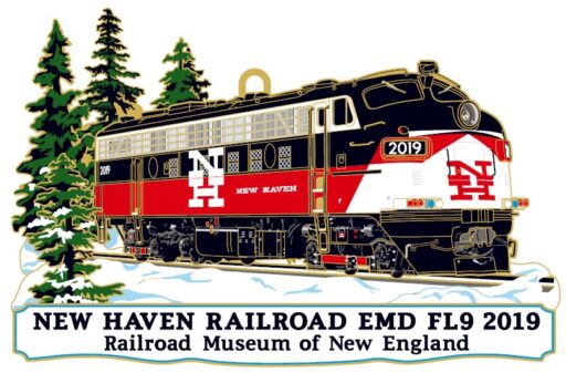 Ornament of a black, red and white locomotive in a snowy forest. It has a white plaque that reads “NEW HAVEN RAILROAD EMD FL9 2019, Railroad Museum of New England.”