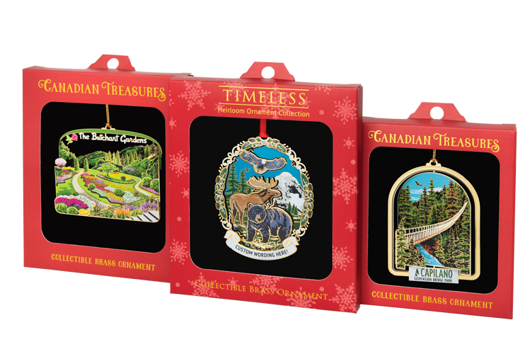 Three ornament boxes side by side with windows: two “Canadian Treasures” boxes (Butchart Gardens and Capilano Suspension Bridge) and a central “Timeless” wildlife design with moose and bear.