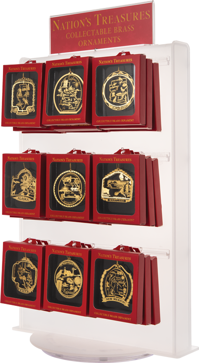 White display full of hanging red boxes with windows showing filigree brass ornaments. A red sign at the top reads “NATION’S TREASURES COLLECTABLE BRASS ORNAMENTS” in yellow.