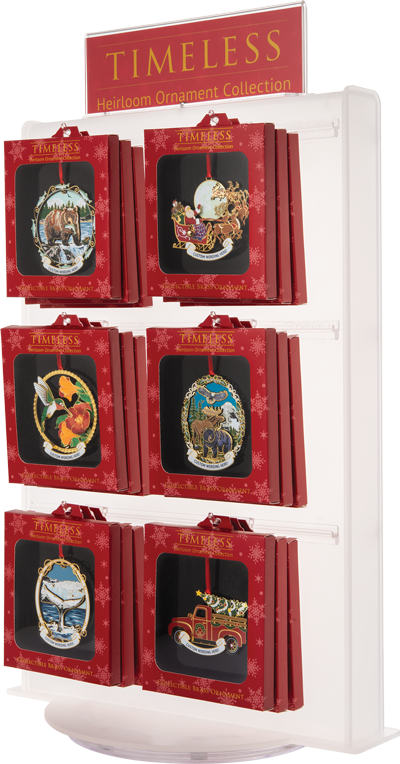 White display full of hanging red boxes with windows showing large colourful ornaments. A red sign at the top reads “TIMELESS Heirloom Ornament Collection” in yellow.