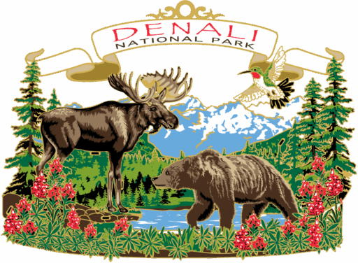 Multi-layered ornament with a moose and brown bear by a river, with pink flowers in front and a mountain scene behind. Above is a white banner that reads “DENALI NATIONAL PARK” in red and black.